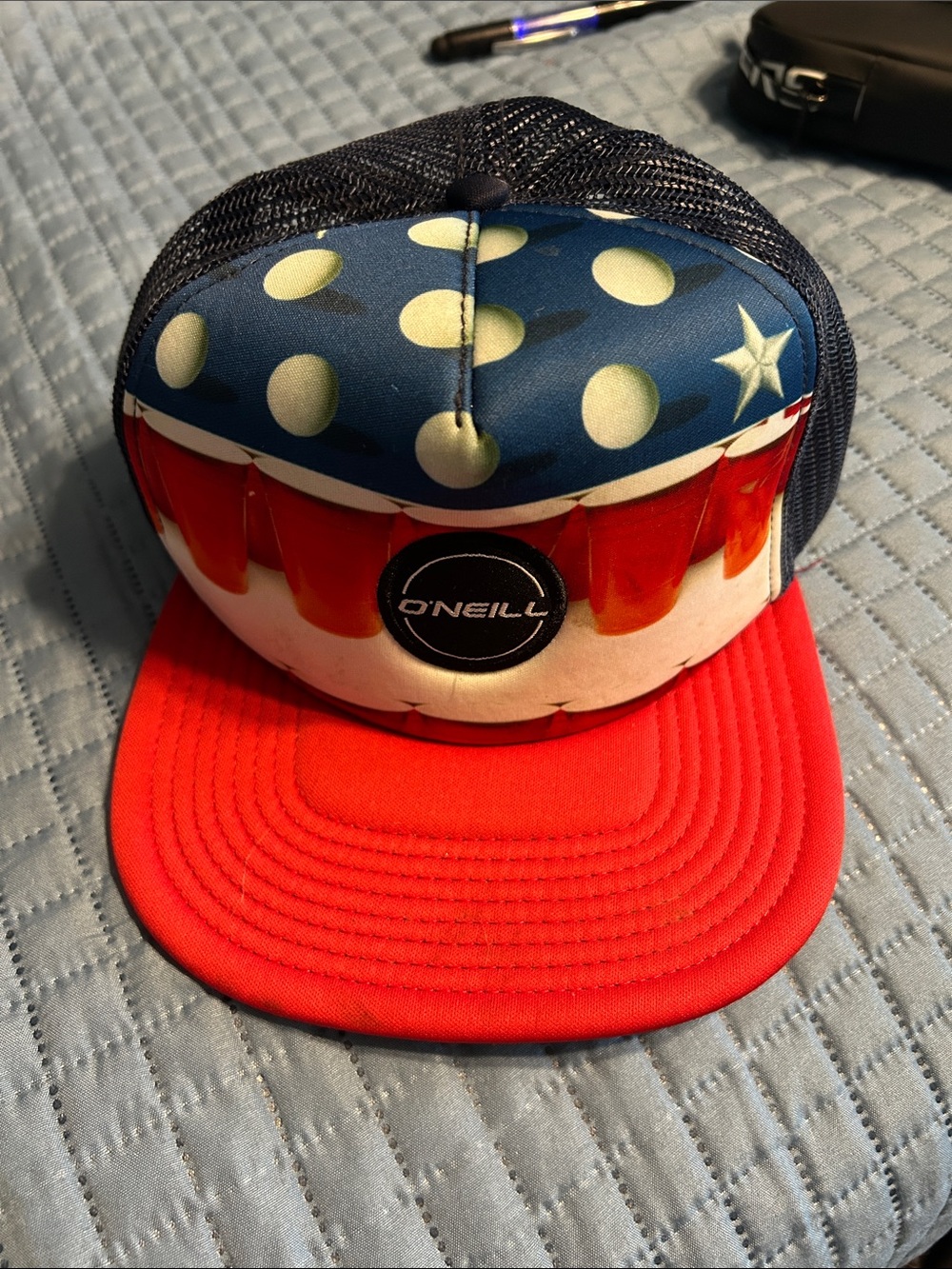Beer Pong Hat on Quilted Surface